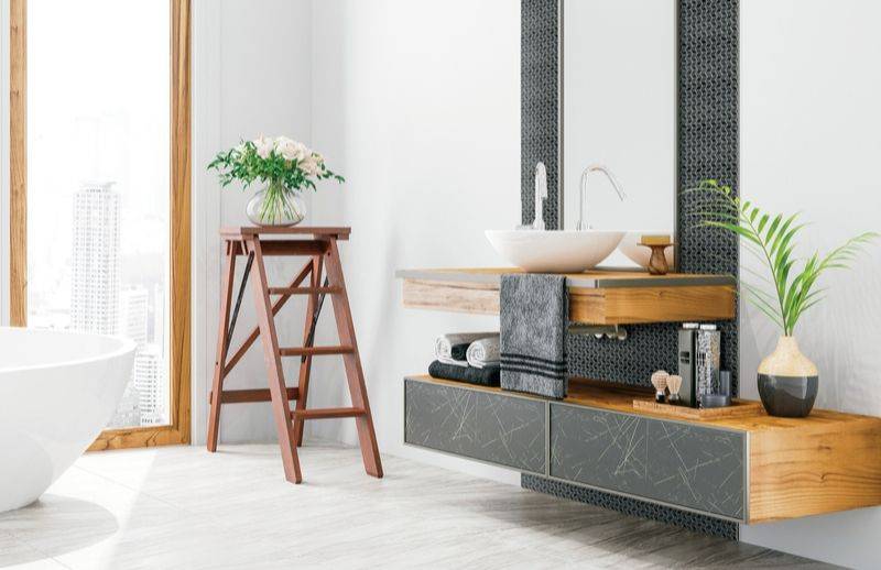 Salle de bain contemporaine avec vanités combinant un effet bois, marbre et une mosaïque murale noire.